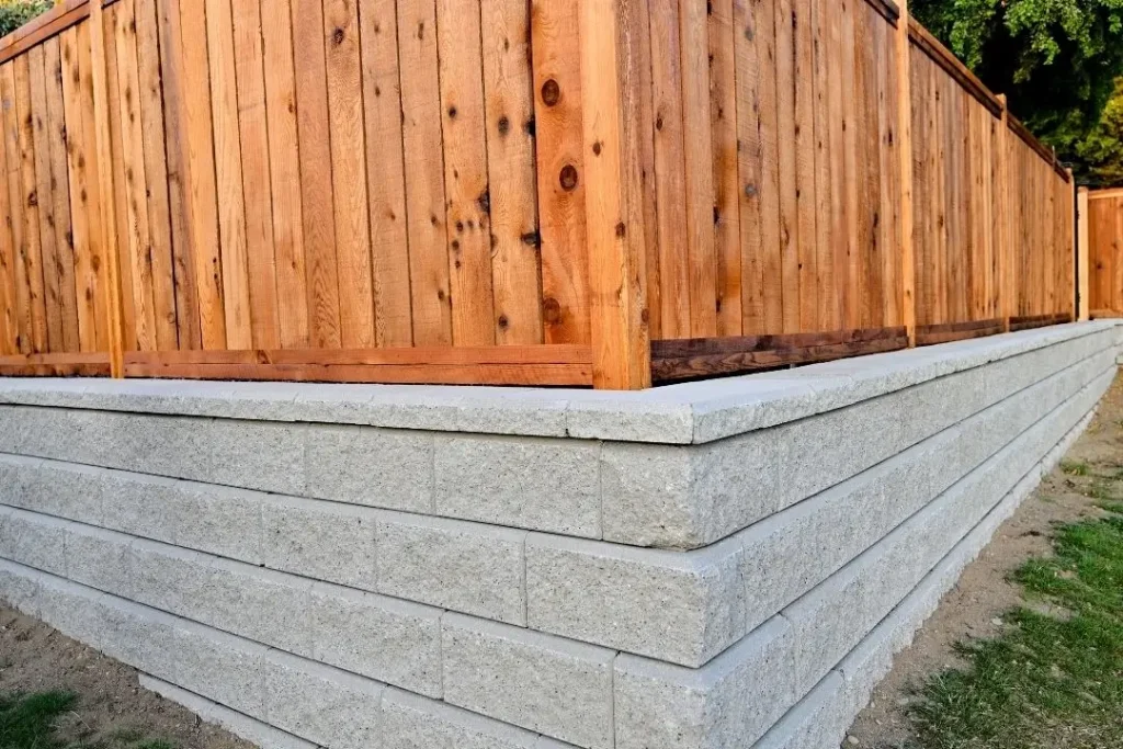 fence on top of retaining wall